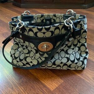 Purse with satin sections and zipper pockets.